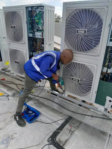 Technician performing HVAC maintenance
